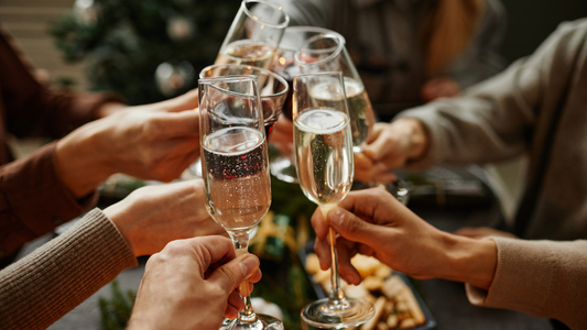 People cheering for the holidays with drinks. An image for a blog post about enjoying the holidays in a healthy gut-friendly way